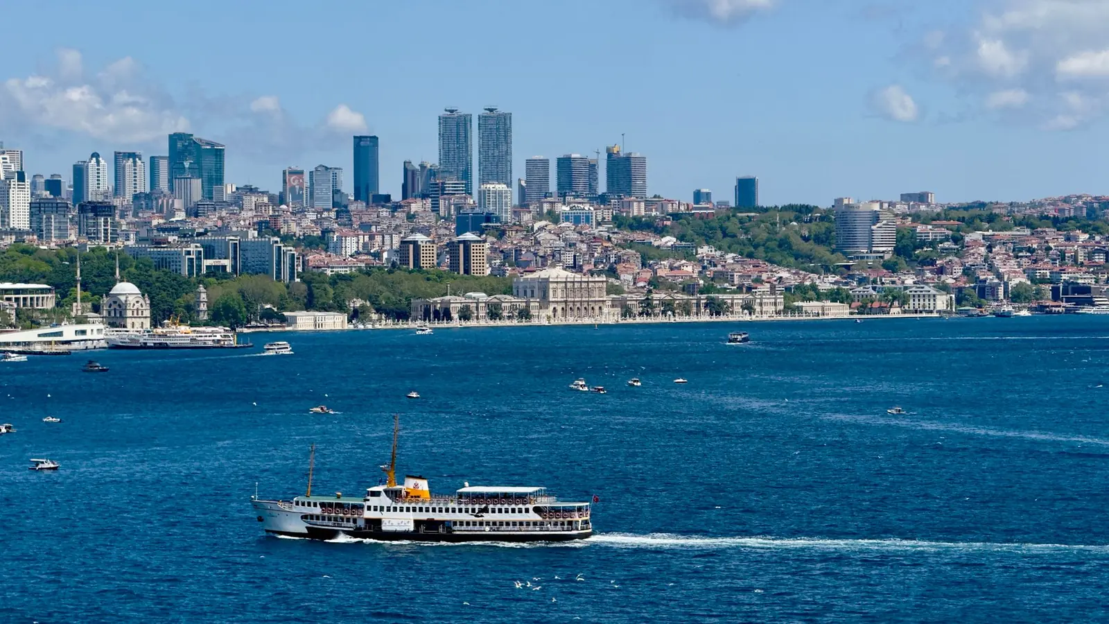 Ferry crossing the Bosphorus below Dolmabahçe Palace and the Beşiktaş skyline