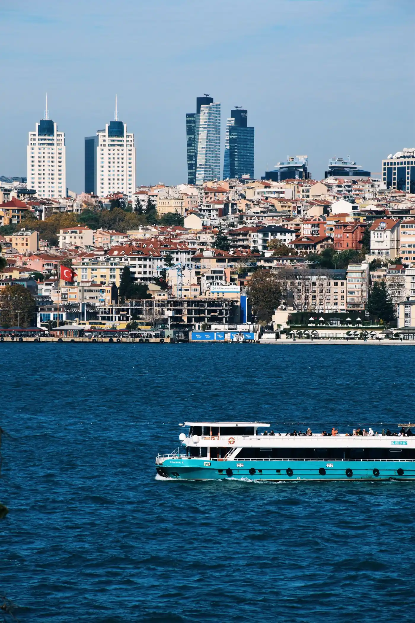 Ferry crossing the Bosphorus below Istanbul's hillside skyline