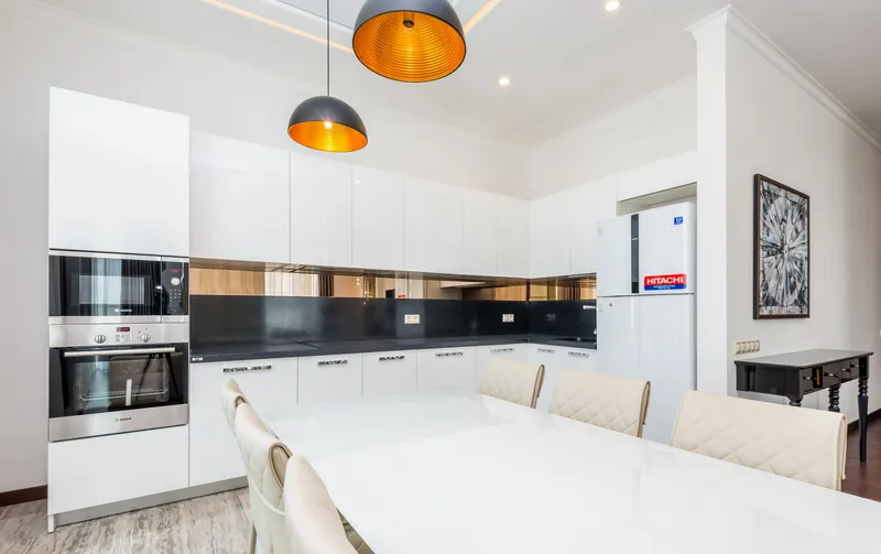 Illustrative stock image for an example listing: Kitchen and dining area of 3-Bedroom Apartment in Moda